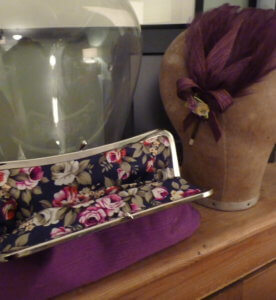 Clutch bag and matching feather head piece.