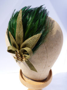 Green feather bespoke hat with green detail.
